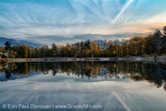 Reflection of forest in Thorne Pond during the spring months. Located in Bartlett, New Hampshire in the White Mountains along Route 302.