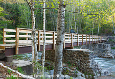 Abutments from Trestle 7 of the East Branch & Lincoln Logging Railroad are used to support the foot bridge along the Lincoln Woods Trail in New Hampshire.